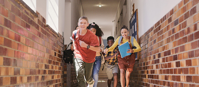 Students happily running in the school hallway
